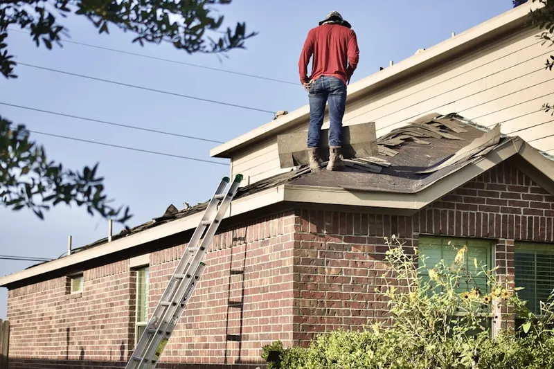 Professional roofer working on a residential roof in Academy